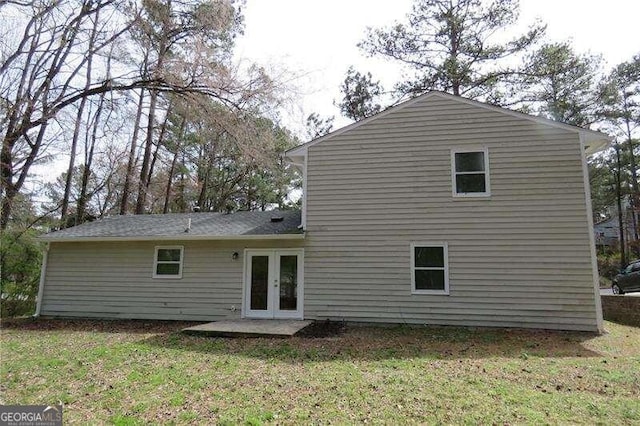 rear view of house featuring french doors and a yard