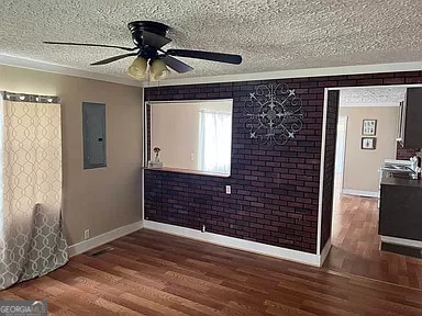 unfurnished room with dark hardwood / wood-style floors, a textured ceiling, and ceiling fan