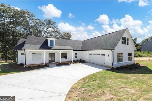 view of front of home with a garage and a front lawn