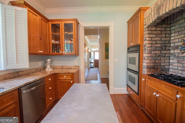 kitchen with pendant lighting, crown molding, stainless steel appliances, and dark hardwood / wood-style floors