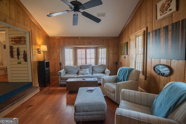 living room featuring crown molding, vaulted ceiling, hardwood / wood-style flooring, and ceiling fan