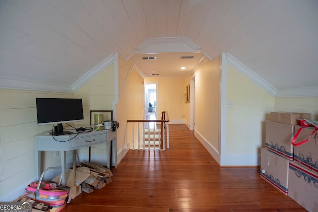 hallway featuring ornamental molding, lofted ceiling, and hardwood / wood-style floors