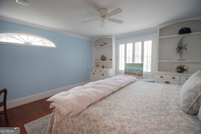 bedroom featuring dark hardwood / wood-style flooring, crown molding, and ceiling fan