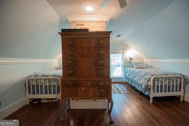 bedroom featuring dark wood-type flooring, ceiling fan, crown molding, and vaulted ceiling