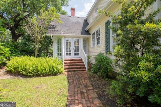 doorway to property with a lawn