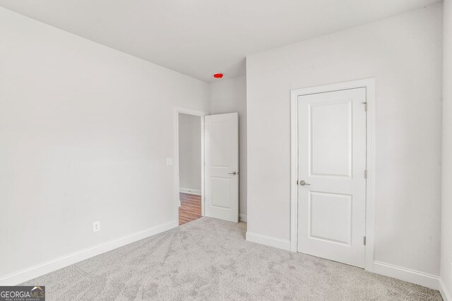 unfurnished bedroom with light carpet