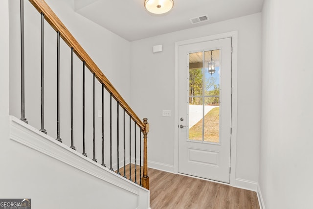 foyer entrance with light wood-type flooring