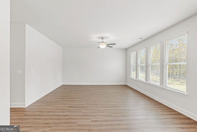 unfurnished room featuring light wood-type flooring and ceiling fan