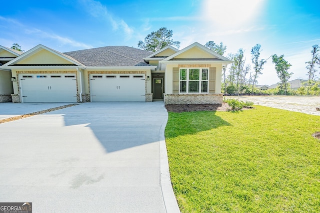 view of front of house featuring a garage and a front lawn