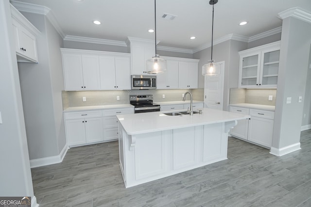 kitchen with sink, appliances with stainless steel finishes, and white cabinetry