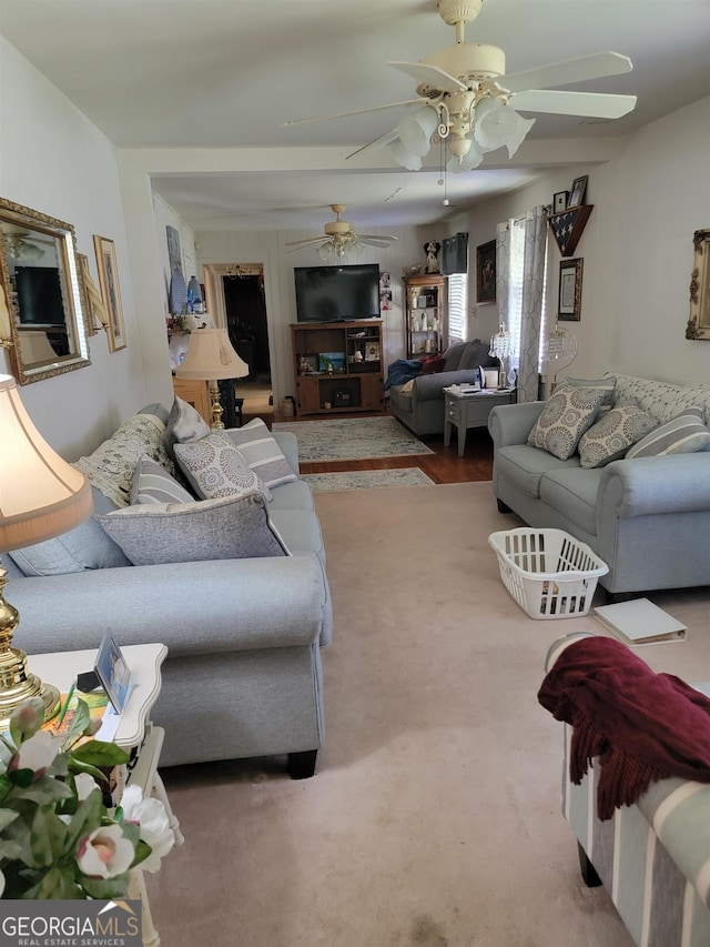 carpeted living room with ceiling fan