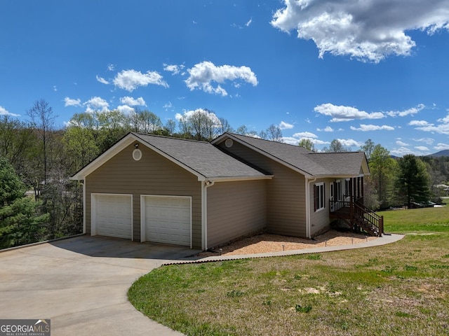 view of front of house featuring a garage and a front lawn