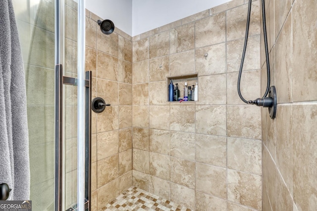 bathroom with a shower with shower door