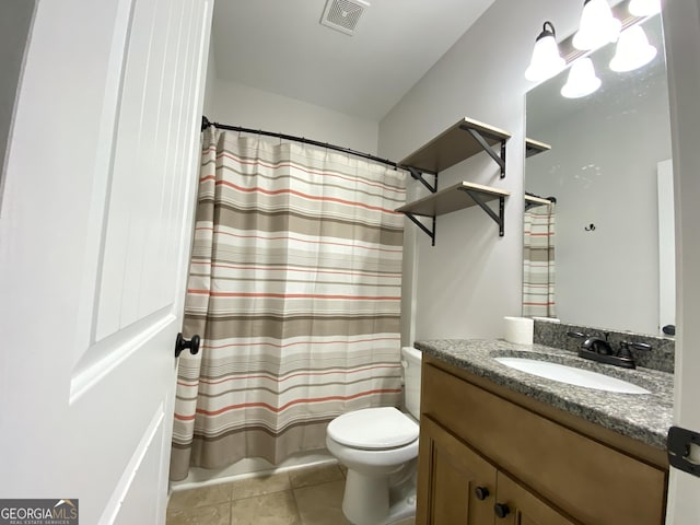 bathroom with vanity, toilet, and tile patterned flooring