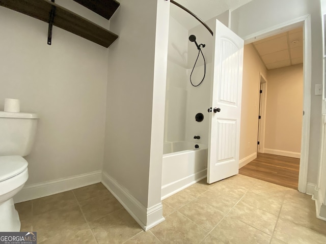 bathroom with toilet and bathtub / shower combination