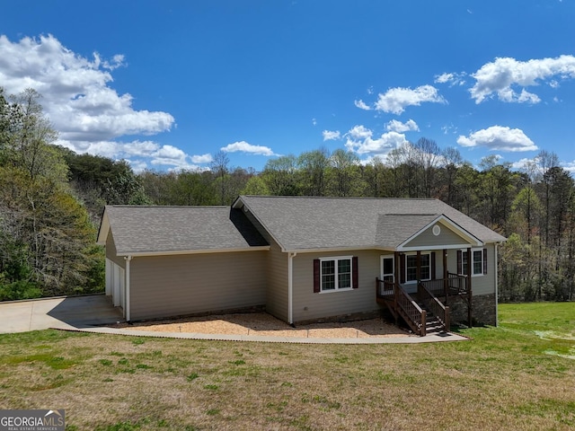 ranch-style home with a garage and a front lawn