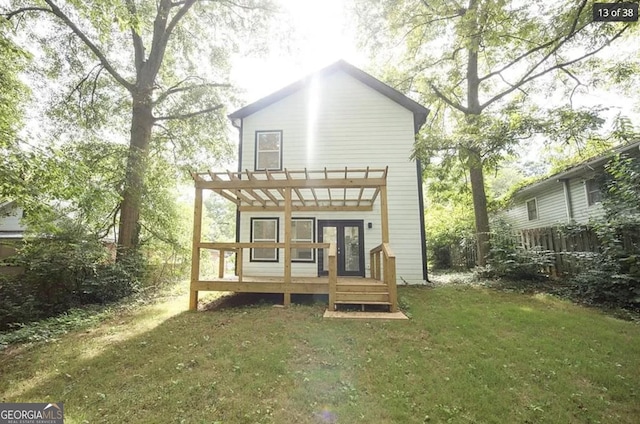 back of property with a pergola, a lawn, and french doors