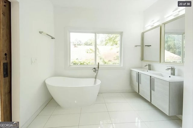 bathroom featuring tile patterned floors, a bathtub, and vanity