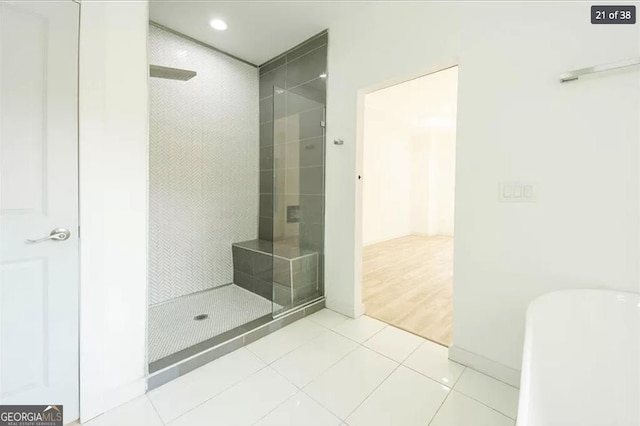 bathroom featuring a tile shower and tile patterned floors