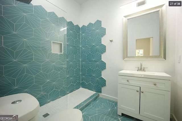 bathroom featuring tile patterned flooring, vanity, and toilet