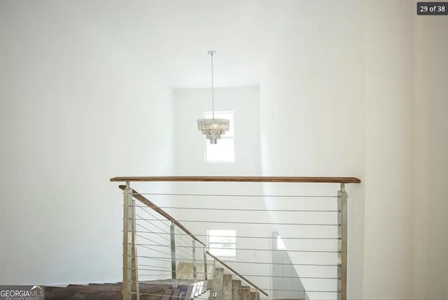 stairs with a chandelier