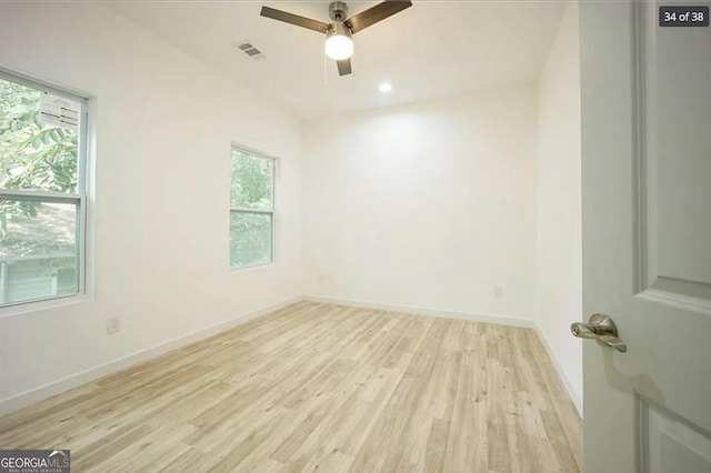 unfurnished room with light hardwood / wood-style floors, ceiling fan, and a healthy amount of sunlight