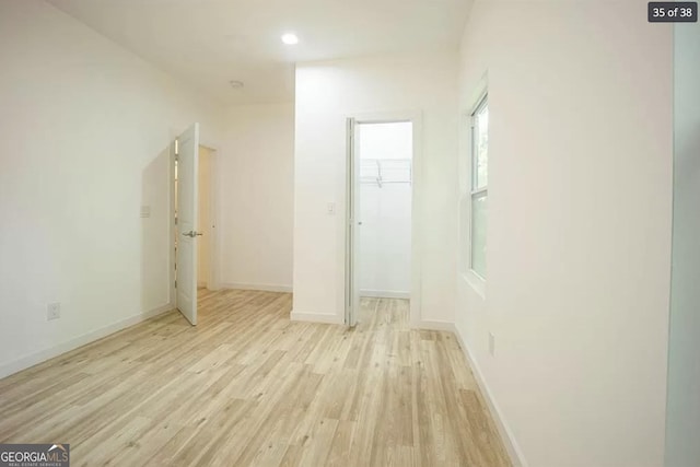 corridor with light hardwood / wood-style flooring