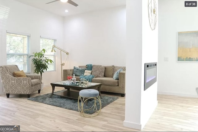 sitting room with light hardwood / wood-style floors and ceiling fan