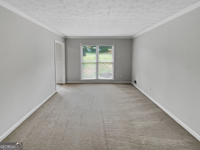 carpeted empty room with crown molding and a textured ceiling