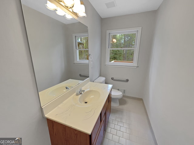 bathroom featuring toilet, tile floors, and large vanity