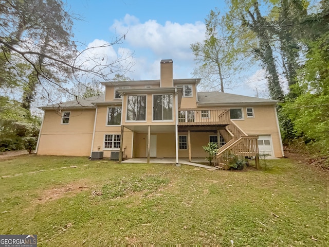 rear view of property with a sunroom, a yard, central AC unit, and a patio