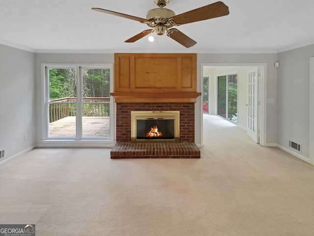 unfurnished living room with a wealth of natural light, light colored carpet, and ceiling fan