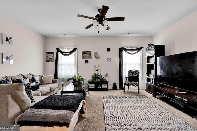 carpeted living room featuring plenty of natural light and ceiling fan