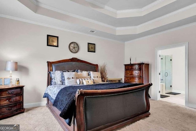 bedroom featuring light colored carpet, crown molding, ensuite bath, and a tray ceiling