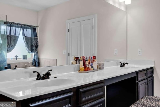 bathroom with dual sinks and oversized vanity