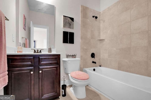 full bathroom featuring vanity, tile floors, toilet, and tiled shower / bath