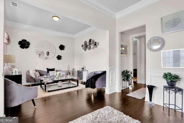 living room with dark wood-type flooring and crown molding