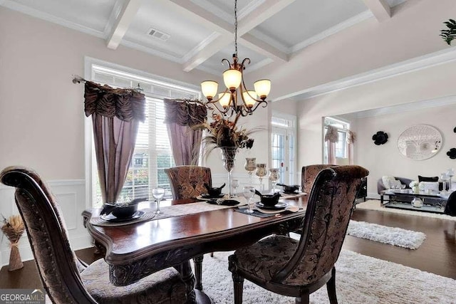 dining area featuring coffered ceiling, a notable chandelier, beam ceiling, crown molding, and hardwood / wood-style flooring