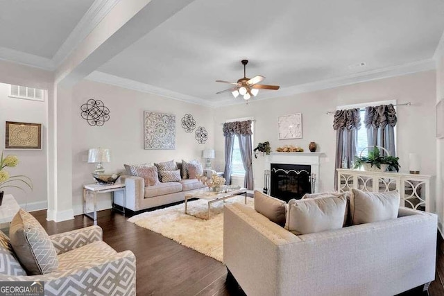 living room with ceiling fan, dark wood-type flooring, and crown molding