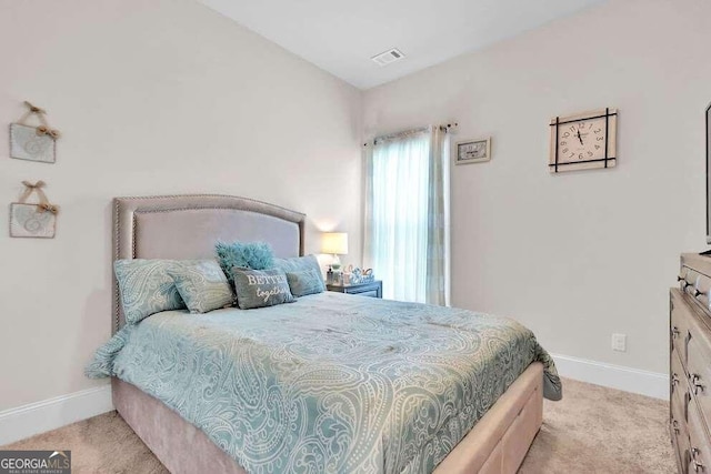 bedroom with light colored carpet