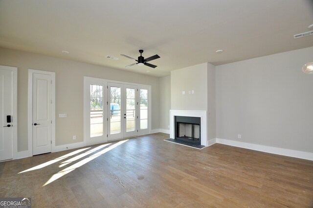 unfurnished living room featuring ceiling fan, light wood-type flooring, and french doors