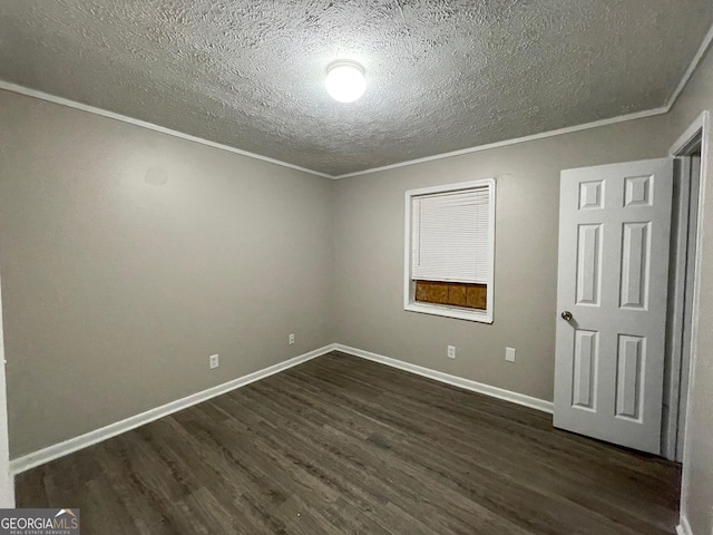 unfurnished bedroom featuring dark wood-style floors, a textured ceiling, baseboards, and crown molding