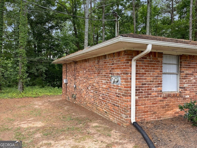 view of property exterior featuring brick siding