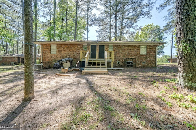 back of property featuring brick siding