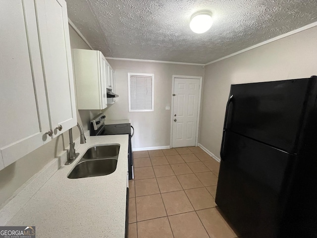 kitchen featuring a sink, white cabinetry, stainless steel range with electric cooktop, light countertops, and freestanding refrigerator