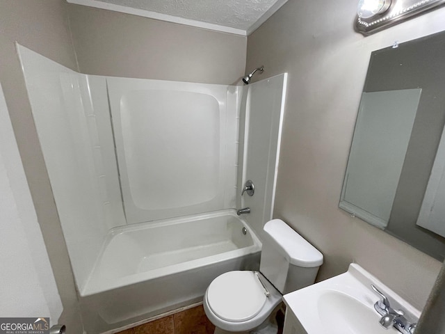 bathroom featuring toilet, a sink, tub / shower combination, and a textured ceiling