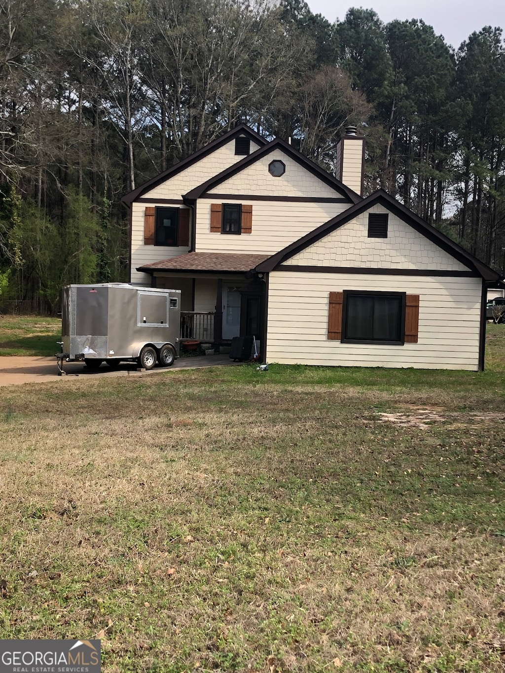 rear view of house with a yard