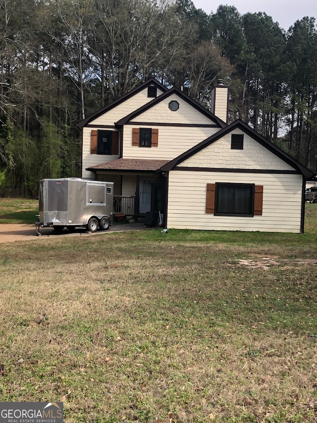 rear view of house with a yard