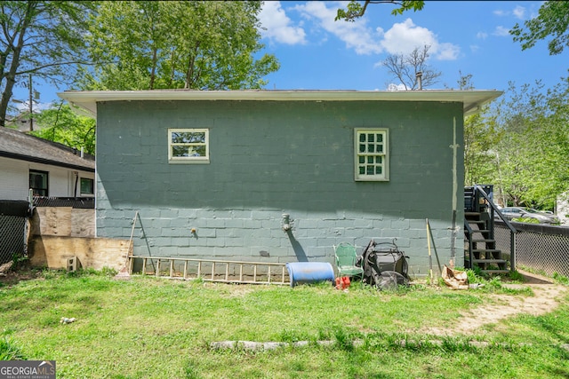 rear view of house featuring a yard