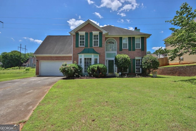 colonial inspired home with a garage and a front lawn